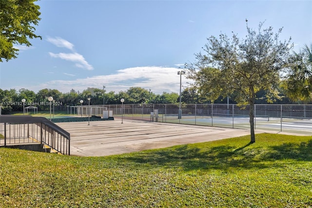 surrounding community with a lawn and tennis court