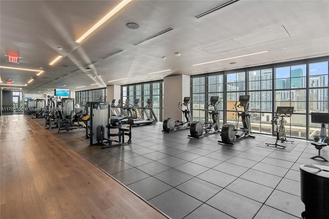 exercise room featuring hardwood / wood-style floors and expansive windows