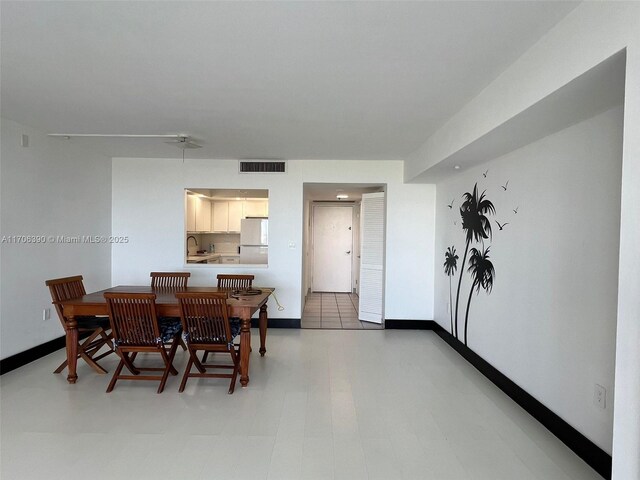 dining area featuring tile patterned flooring and sink