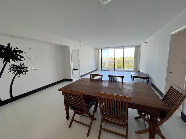 dining area featuring floor to ceiling windows