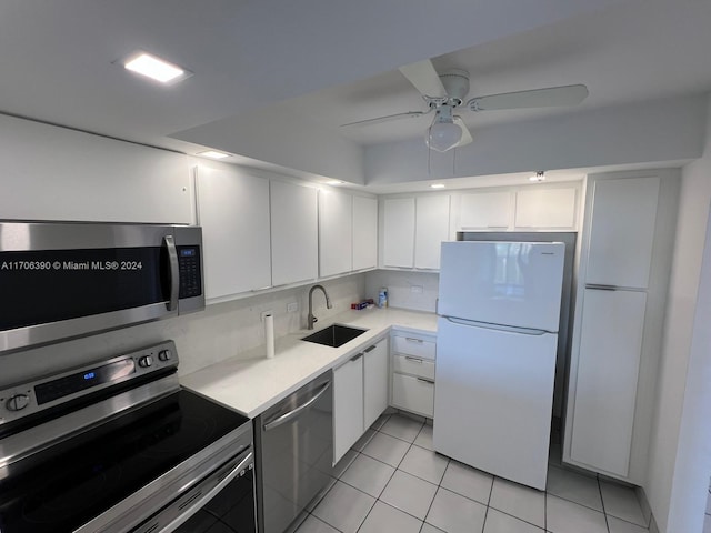 kitchen featuring white cabinetry, sink, ceiling fan, stainless steel appliances, and light tile patterned floors