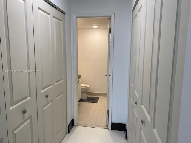 corridor with light tile patterned flooring