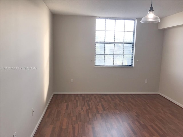 spare room featuring dark wood-type flooring