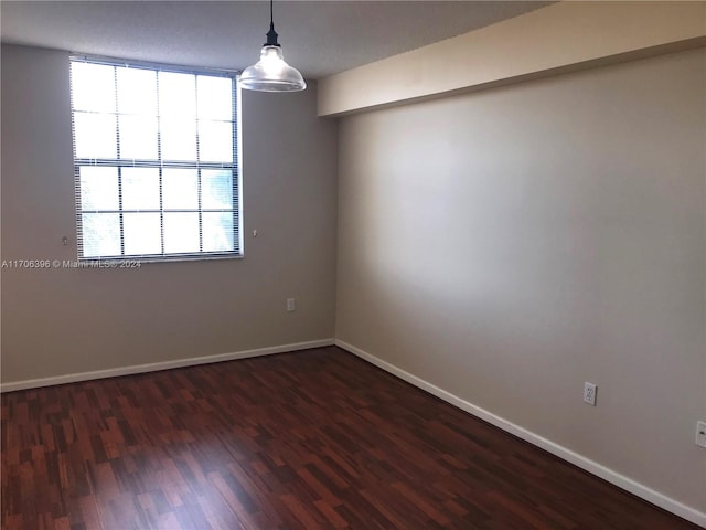 spare room featuring dark hardwood / wood-style floors