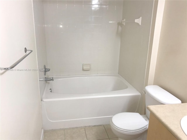 full bathroom featuring tile patterned flooring, vanity, toilet, and tiled shower / bath