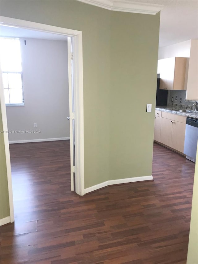 hall with dark hardwood / wood-style floors, crown molding, and sink