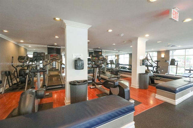 exercise room featuring hardwood / wood-style flooring, a wealth of natural light, and ornamental molding