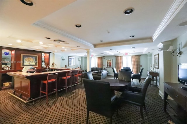 interior space with dark carpet, a raised ceiling, and crown molding