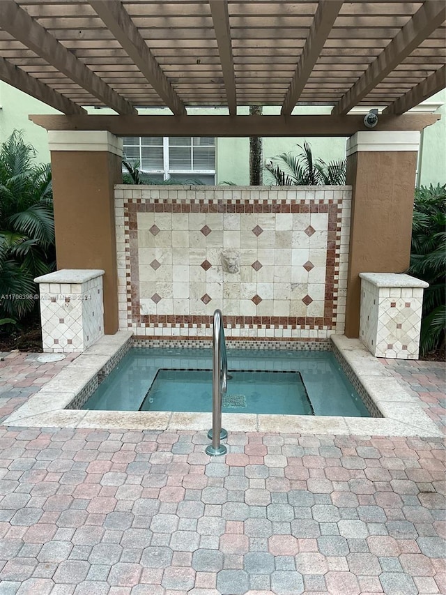 view of swimming pool with an in ground hot tub and a pergola