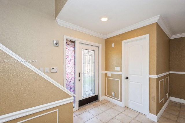 entrance foyer featuring crown molding and light tile patterned floors