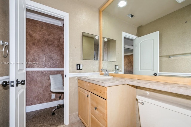 bathroom with tile patterned floors, vanity, and toilet