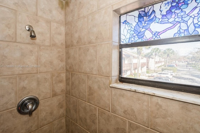 interior details featuring tiled shower