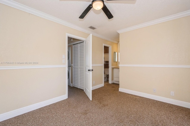 unfurnished bedroom with a textured ceiling, ceiling fan, carpet floors, and ornamental molding