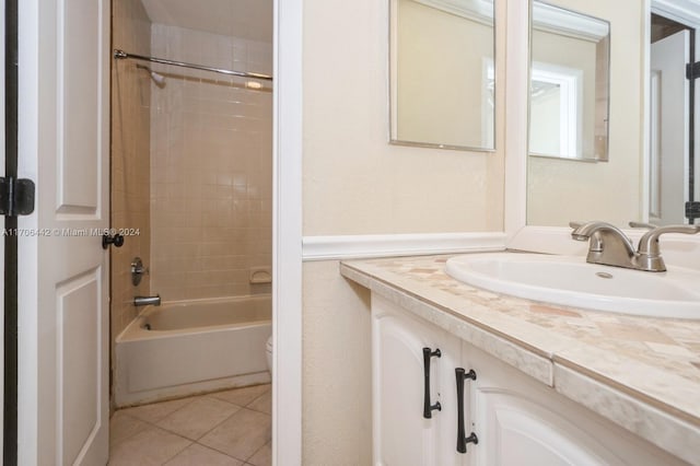 full bathroom featuring tile patterned flooring, tiled shower / bath combo, toilet, and vanity