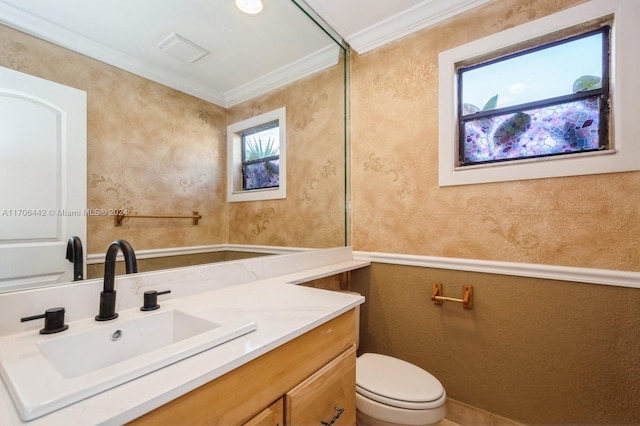 bathroom with vanity, toilet, and crown molding