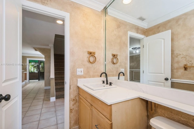 bathroom with tile patterned floors, vanity, toilet, and crown molding