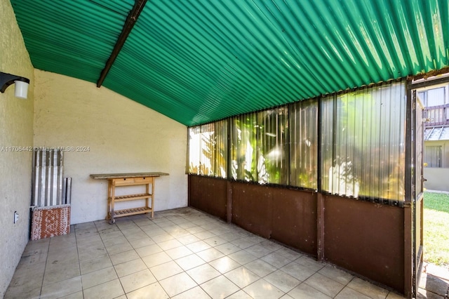 unfurnished sunroom with lofted ceiling