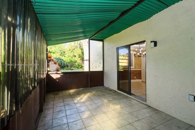 unfurnished sunroom featuring a notable chandelier