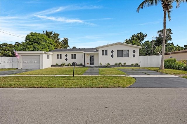 single story home with a front yard and a garage