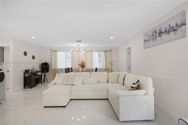 living room with light tile patterned flooring and a chandelier