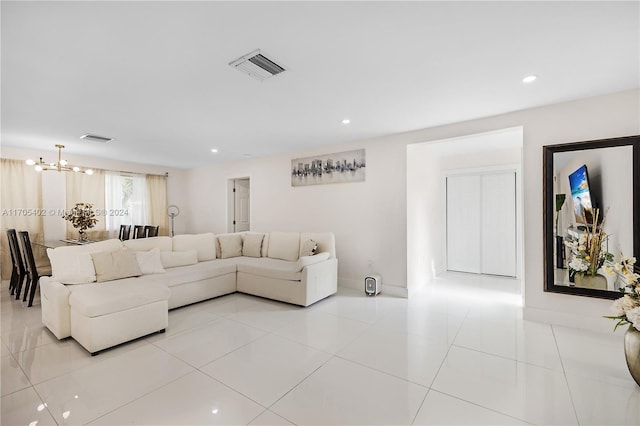 living room featuring a chandelier and light tile patterned floors