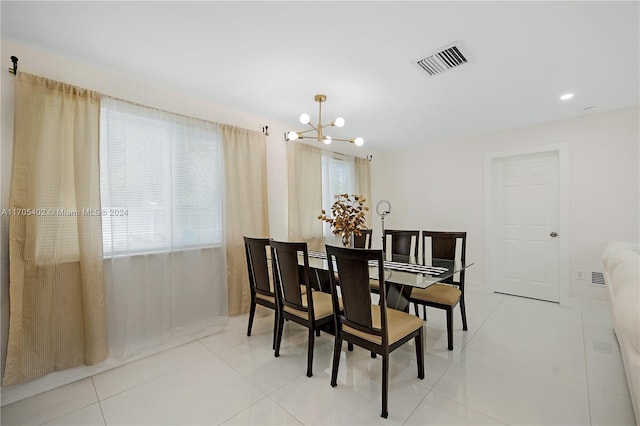 dining area with light tile patterned floors and a notable chandelier