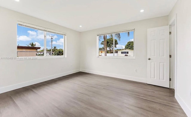 empty room with hardwood / wood-style flooring