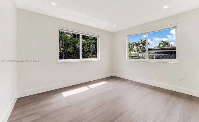 unfurnished room with wood-type flooring