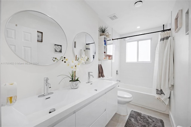 full bathroom with tile patterned floors, vanity, toilet, and shower / bath combo with shower curtain