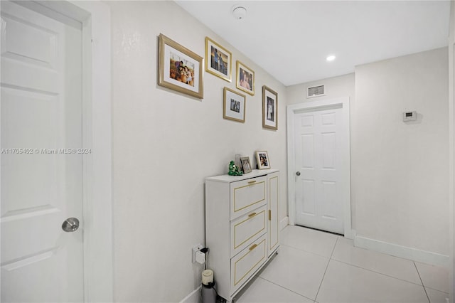 hallway featuring light tile patterned flooring