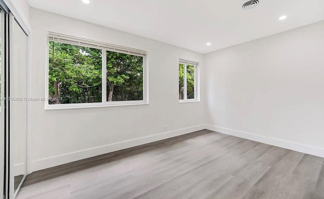 spare room with wood-type flooring