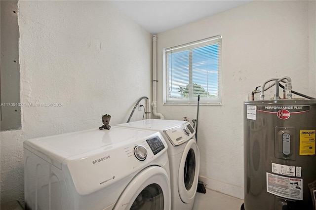 washroom with water heater and washer and dryer