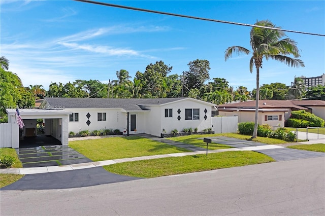 ranch-style house featuring a front yard and a carport