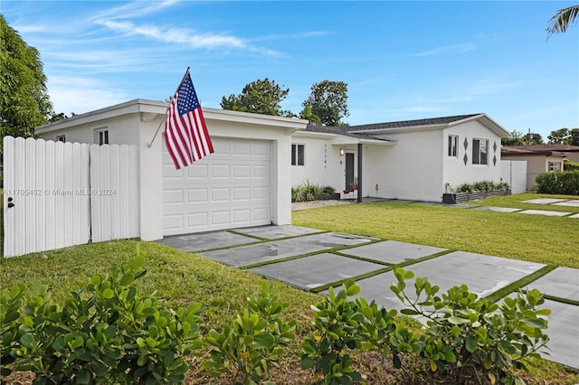 single story home featuring a garage and a front lawn