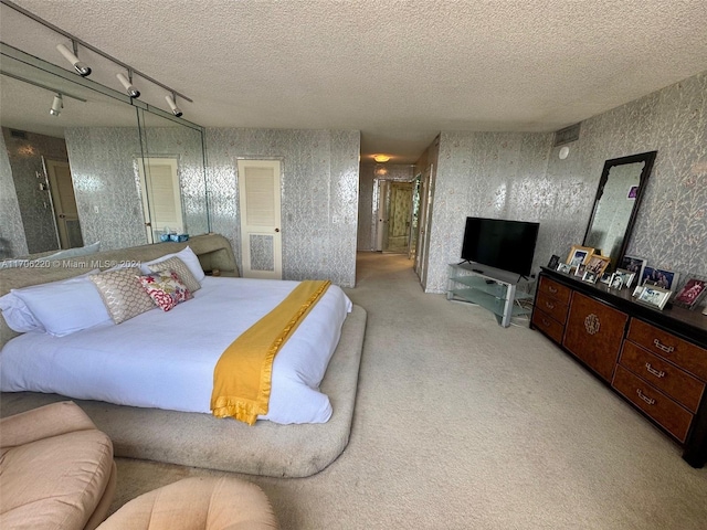 hall with tile patterned flooring and a textured ceiling