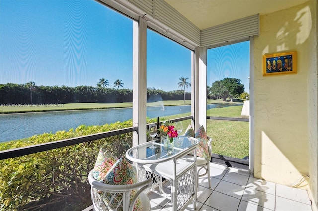 sunroom / solarium featuring a water view