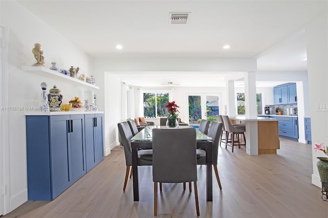 dining room with french doors and light hardwood / wood-style floors