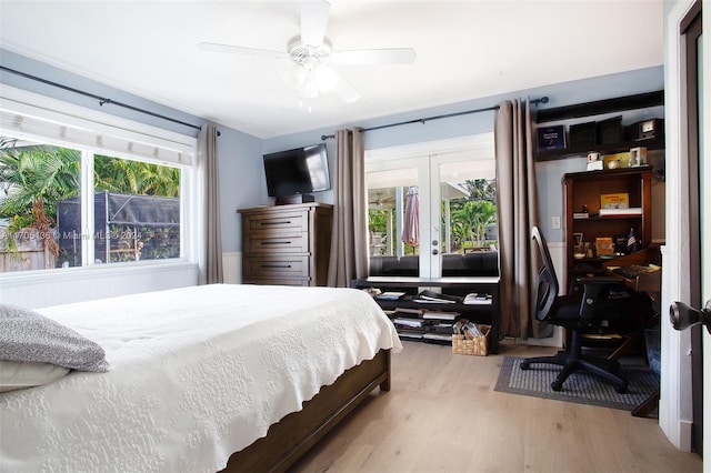 bedroom featuring hardwood / wood-style floors, ceiling fan, and french doors