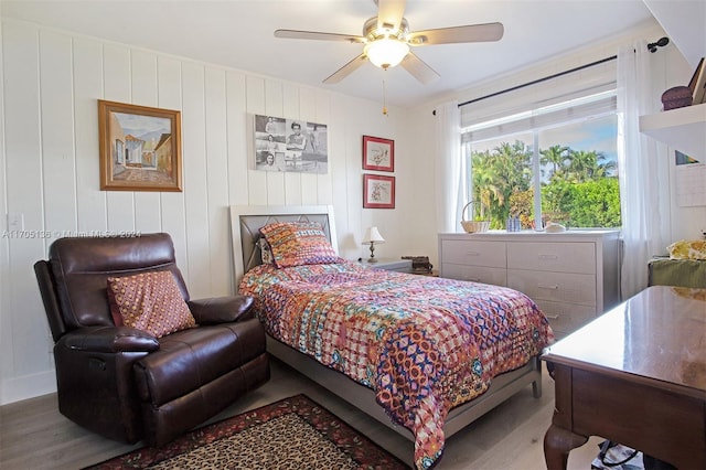 bedroom with ceiling fan and wood-type flooring