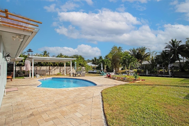 view of pool featuring a yard and a patio area