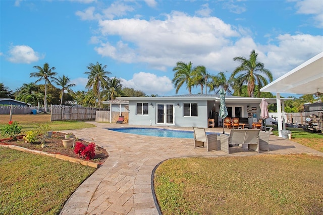 view of swimming pool with french doors, an outdoor hangout area, a patio area, and a lawn