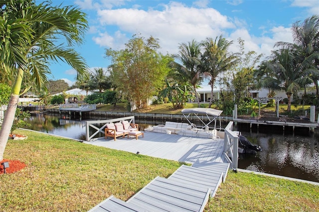 view of dock featuring a yard and a water view