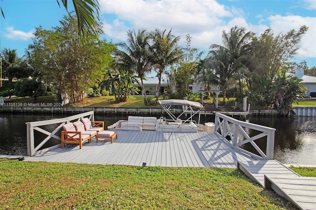 view of dock featuring a yard and a water view