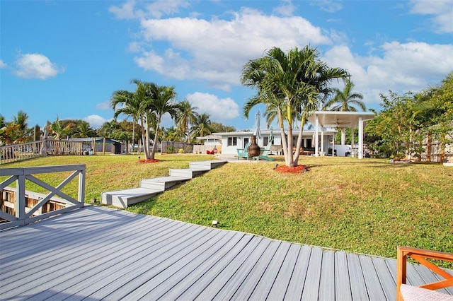 wooden terrace with a lawn