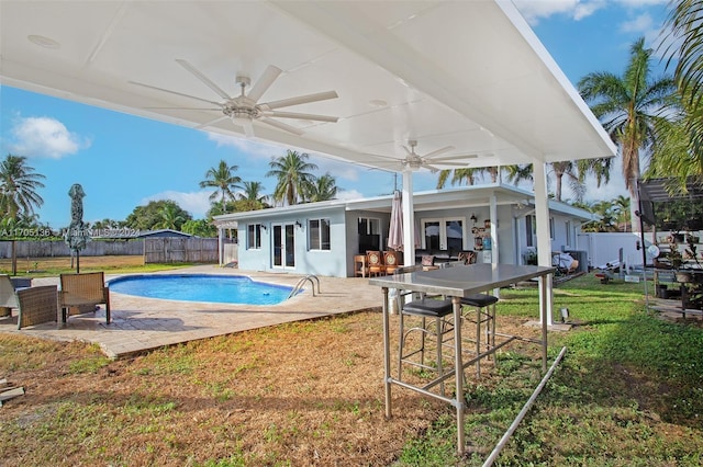 view of pool featuring ceiling fan, a patio area, and a yard