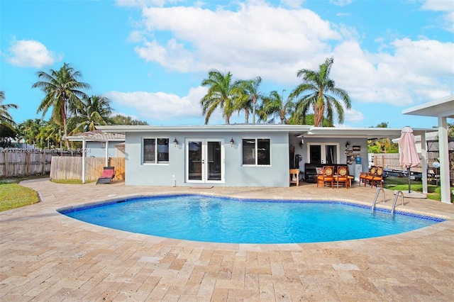 view of swimming pool featuring french doors and a patio