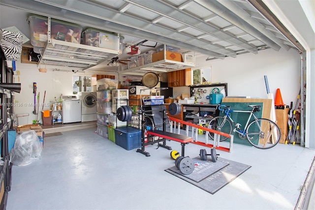 garage with washer and dryer and a garage door opener