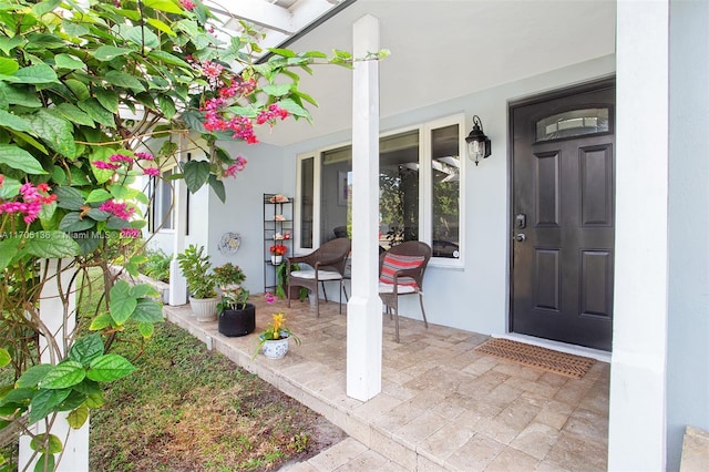 view of exterior entry featuring covered porch