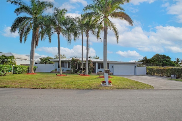 ranch-style home featuring a garage and a front lawn