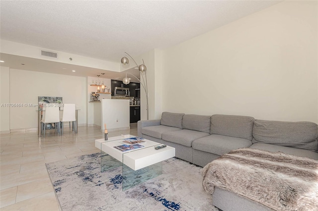 tiled living room with a textured ceiling